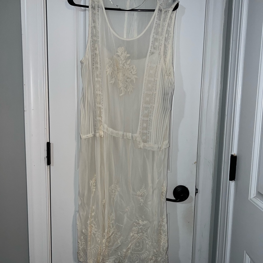 Sleeveless white dress with slip.